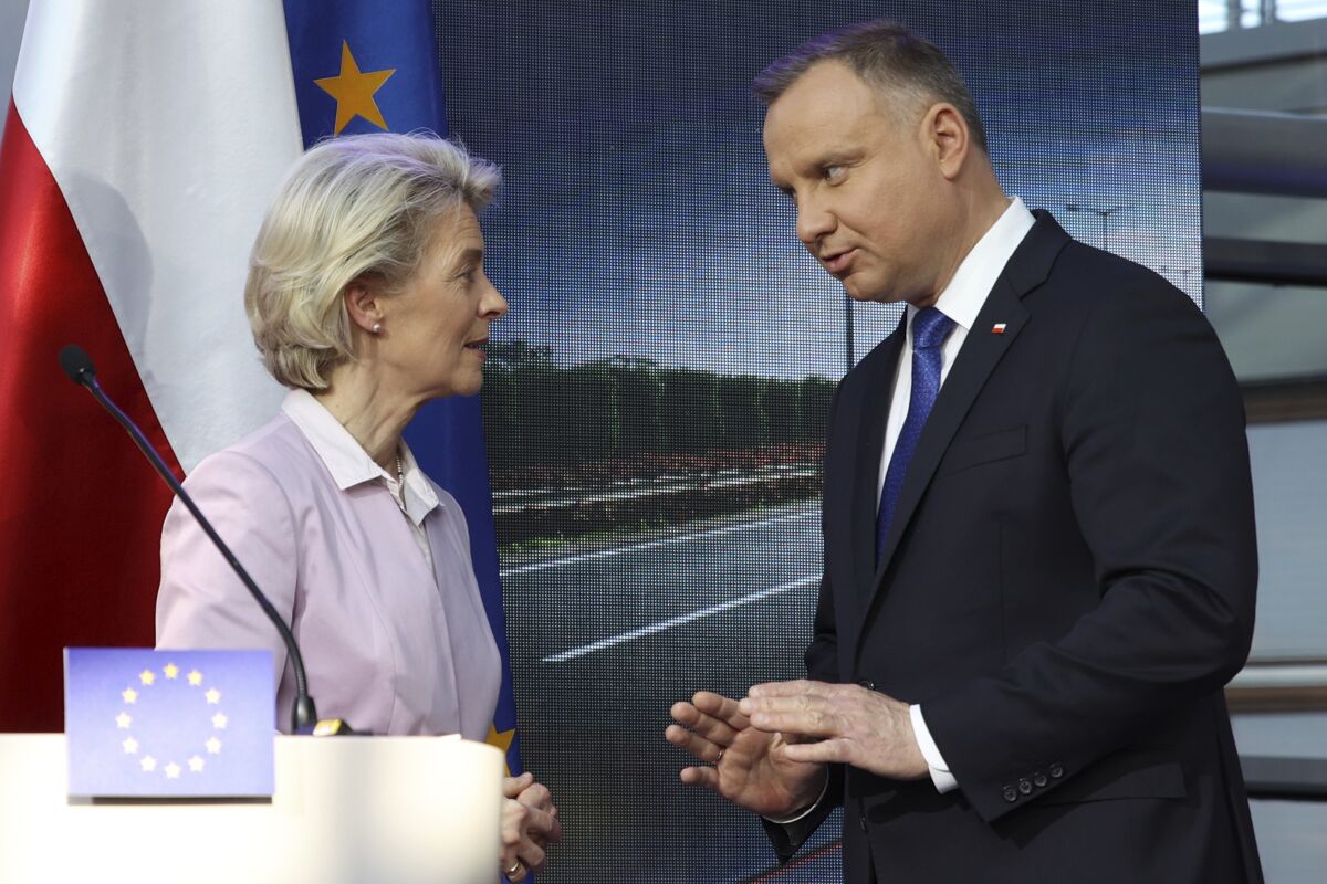 Polish President Andrzej Duda, right, and European Commission President Ursula von der Leyen speak after at a joint news conference with Poland's Prime Minister Mateusz Morawiecki at the headquarters of Poland's Power Grid in Konstancin-Jeziorna, Poland, Thursday, June 2, 2022. The independence of Poland's courts is at the heart of a dispute with the European Union, which has withheld billions of euros in pandemic recovery funds. (AP Photo/Michal Dyjuk)