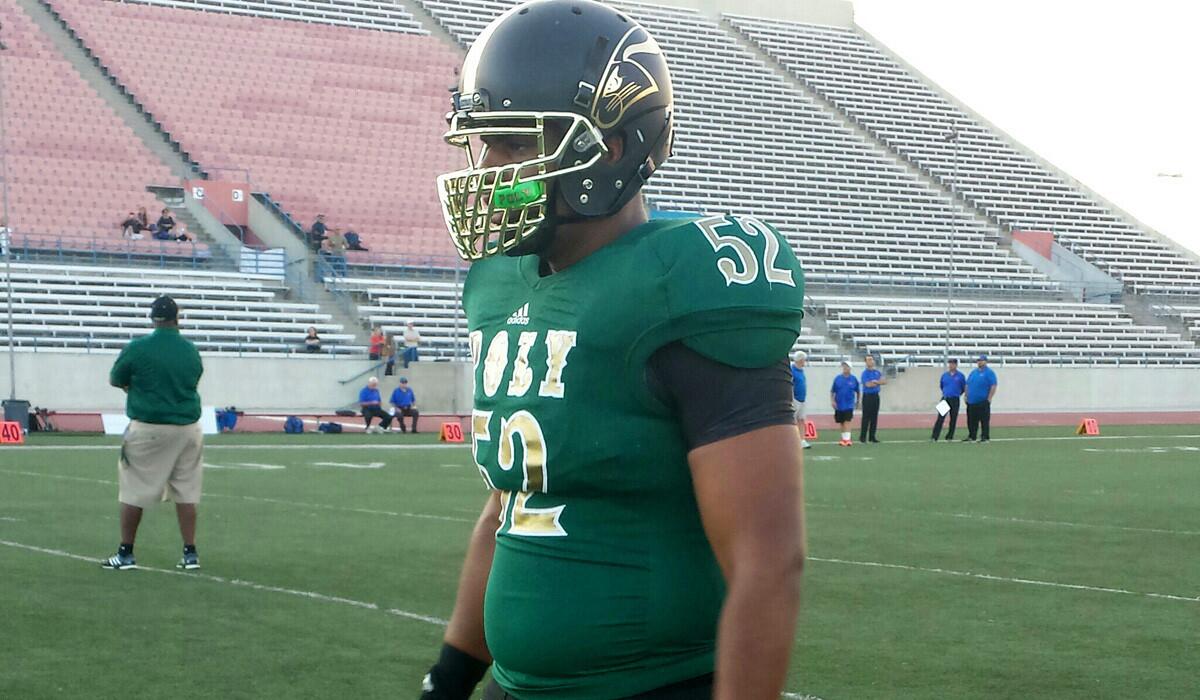 Long Beach Poly defensive lineman Joseph Wicker gets set to warm up before the game against Westlake on Friday night at Veterans Stadium.