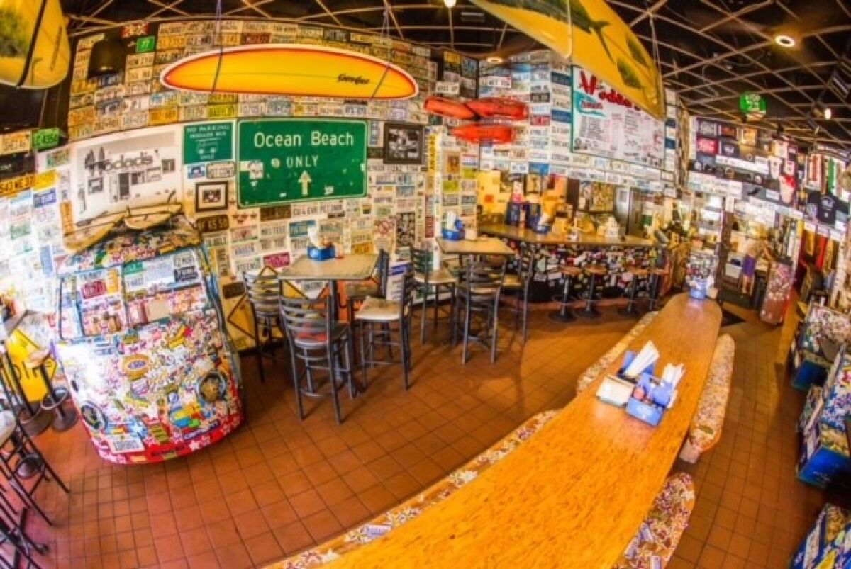Hodad's interior is plastered with stickers, posters, historic photos, vintage bric-a-brac and personalized license plates.