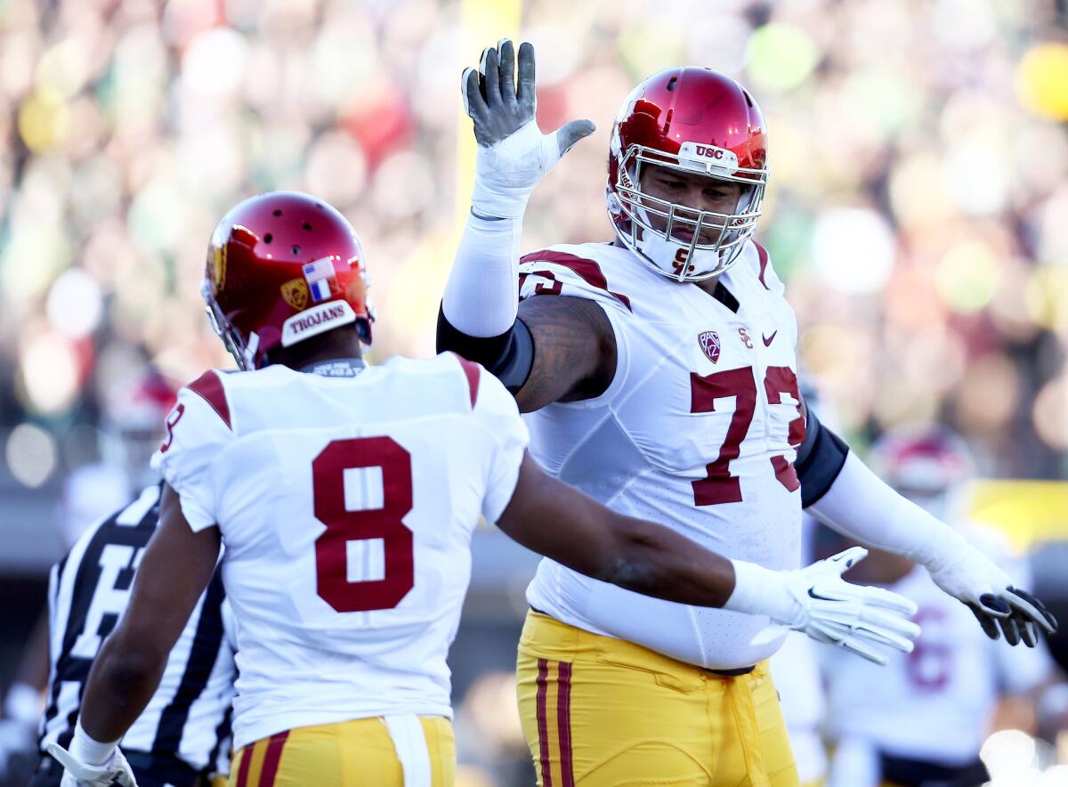 USC offensive tackle Zach Banner, right, high-fives cornerback Iman Marshall during the first half of a game against Oregon on Nov. 21.