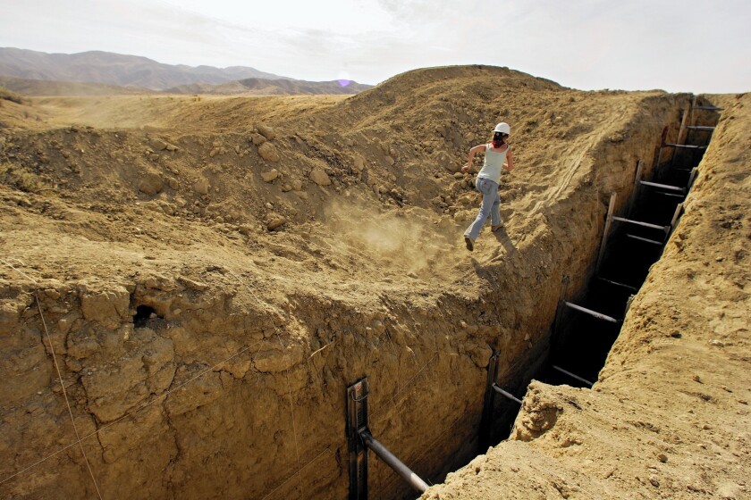 Studying a trench that reveals lines in the sediment helps a team of geologists construct a history of earthquakes on the San Andreas fault in San Luis Obispo County.