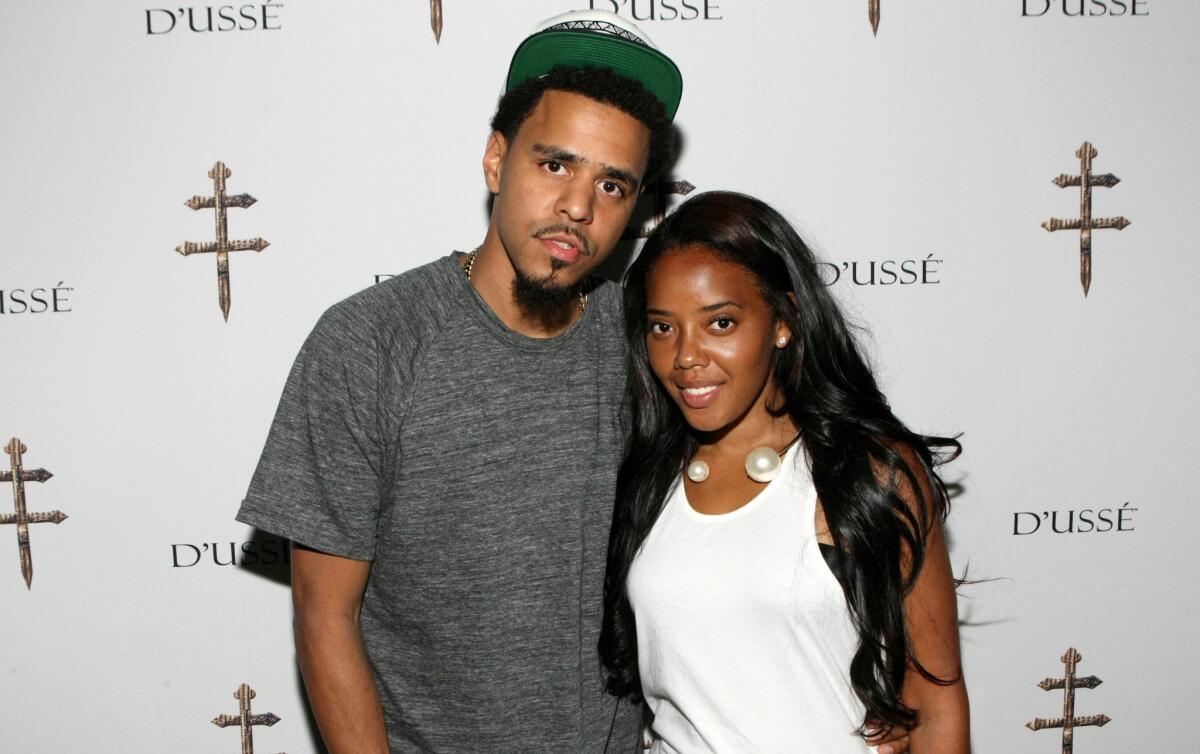Rapper J Cole, shown in July in East Rutherford, N.J. with TV personality Angela Simmons, has rush released a song in response to the recent shooting of an unarmed black teenager in Ferguson, Mo.