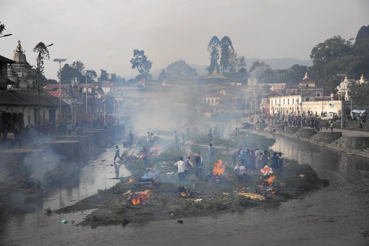 Flames rise from the funeral pyres of earthquake victims along the Bagmati River in Katmandu, Nepal.