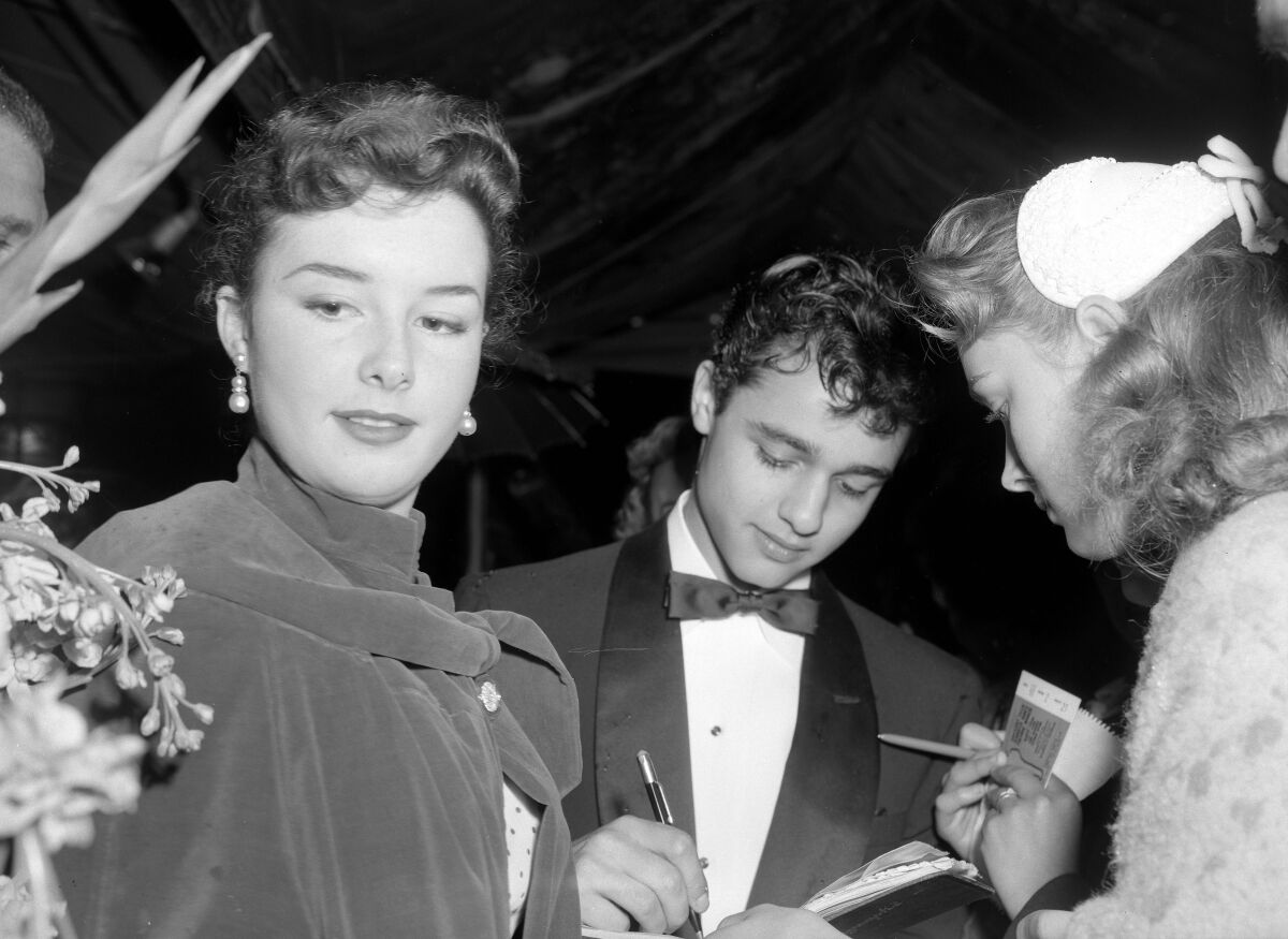 Actor Sal Mineo with actress Gigi Perreau signing autographs