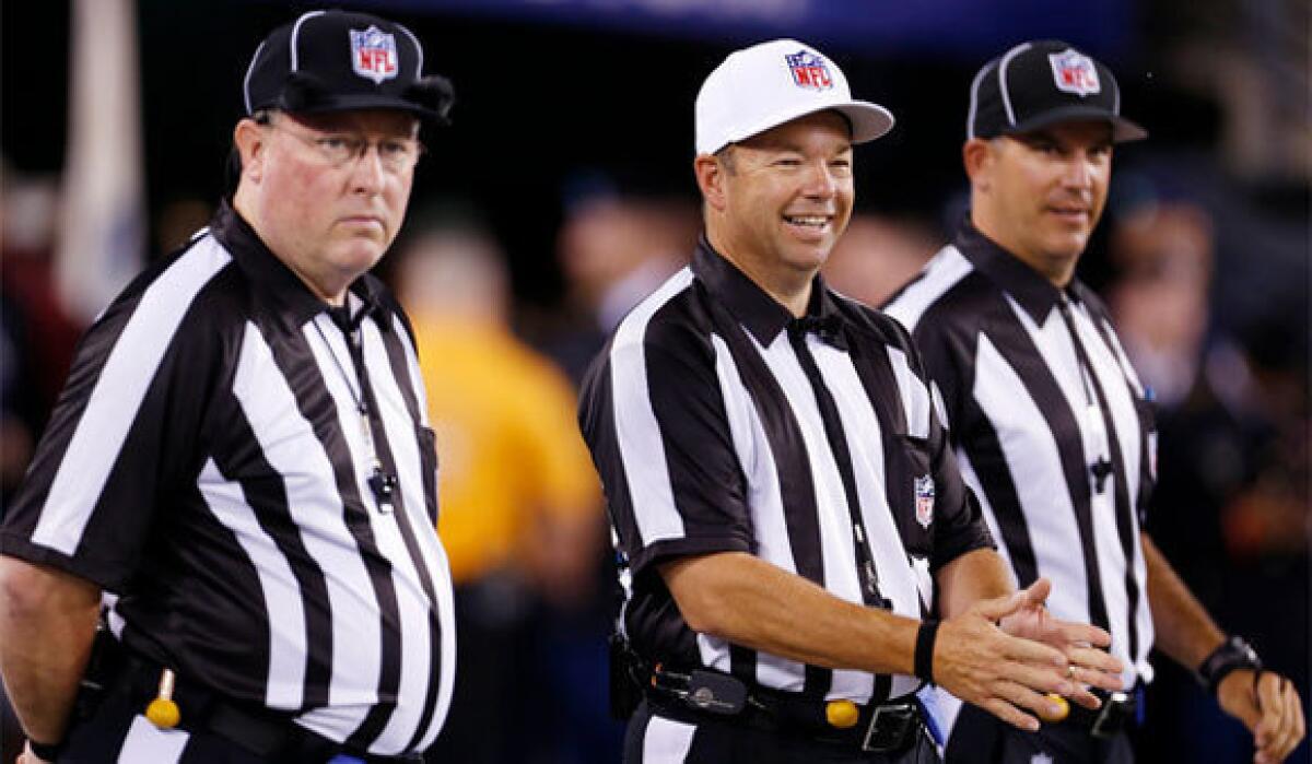 Referee Jim Core, center, stands with fellow replacement officials before the New York Giants-Dallas Cowboys game.