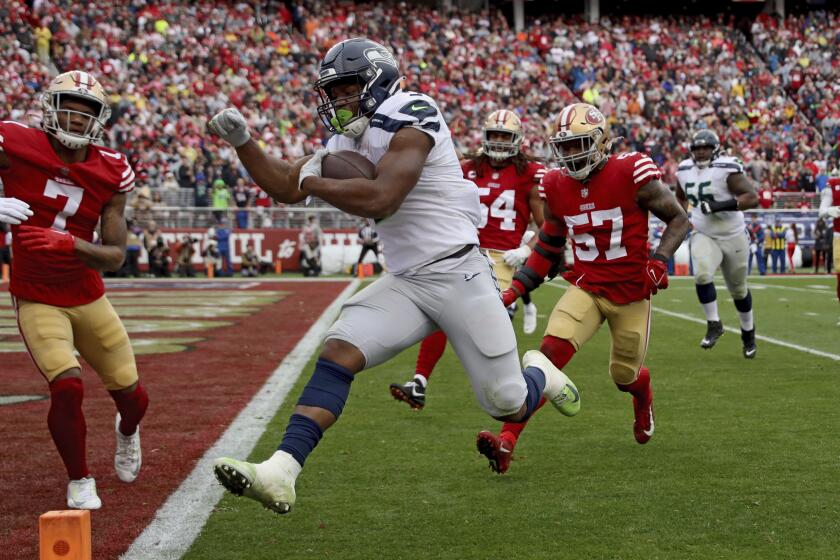 FILE - Seattle Seahawks running back Kenneth Walker III (9) runs for a touchdown during the team's NFL wild-card playoff football game against the San Francisco 49ers on Jan. 14, 2023, in Santa Clara, Calif. San Francisco quarterback Brock Purdy, Walker and New York Jets wide receiver Garrett Wilson are the finalists for AP Offensive Rookie of the Year. (AP Photo/Scot Tucker, File)