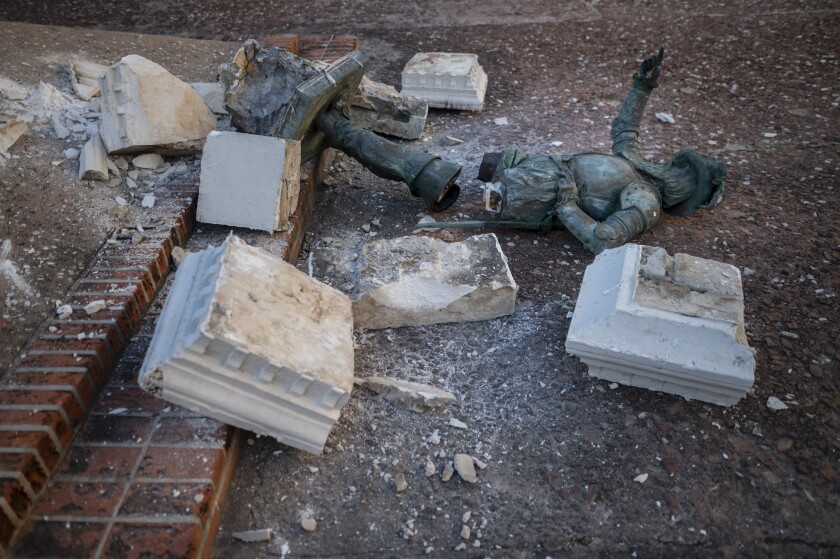 A monument of Spanish explorer Juan Ponce de León lays in pieces in Plaza San Jose in San Juan, Puerto Rico, Monday, Jan. 24, 2022. Unknown people toppled the in the pre-dawn hours of Monday ahead of a visit of King Felipe VI to the U.S. Caribbean territory of Puerto Rico. (AP Photo/Carlos Giusti)
