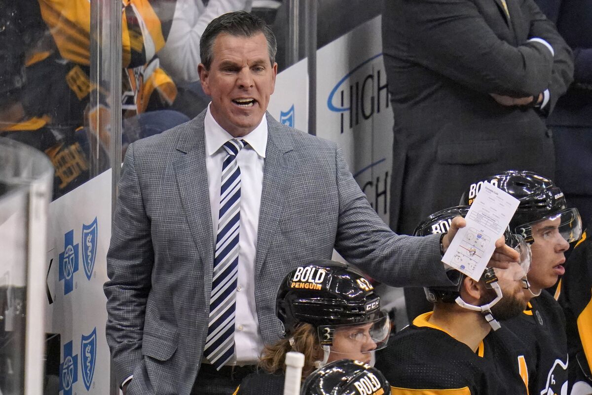 Pittsburgh Penguins head coach Mike Sullivan gives instructions during the first period of an NHL hockey game against the Tampa Bay Lightning in Pittsburgh, Tuesday, Oct. 26, 2021. The Lightning won 5-1. (AP Photo/Gene J. Puskar)