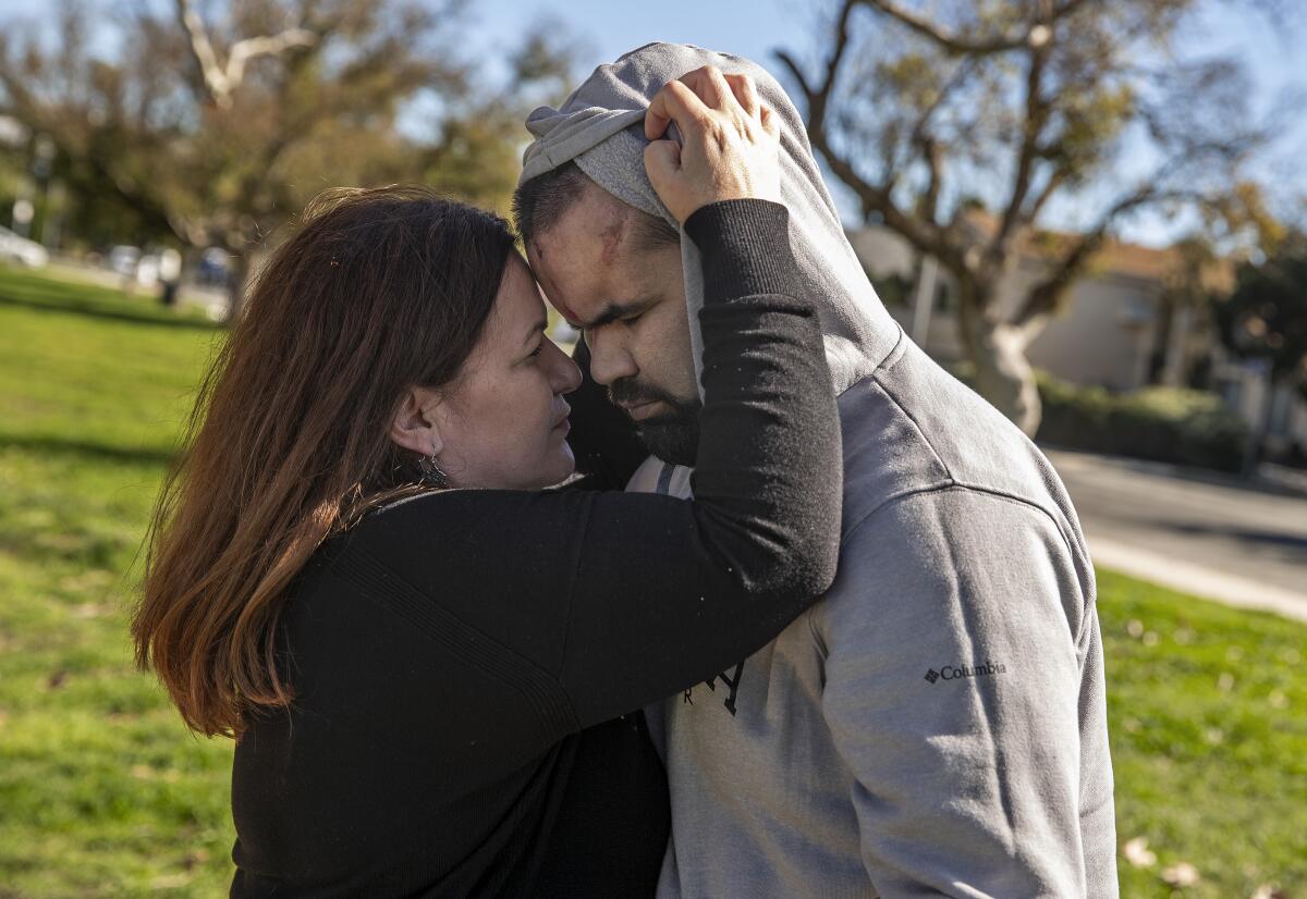 A woman embraces her son