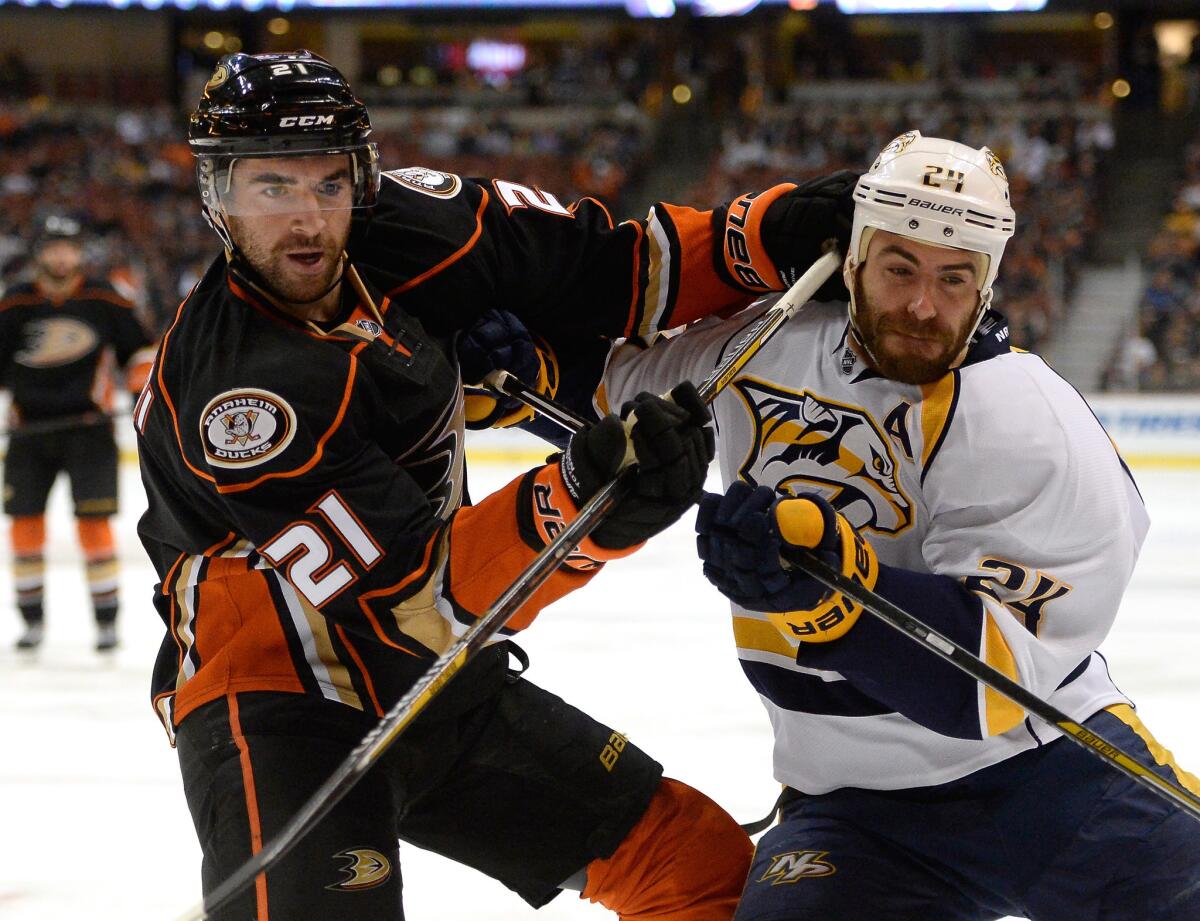 Kyle Palmieri (21) battles Nashville's Eric Nystrom along the boards during a Ducks game on Jan. 4, 2015.