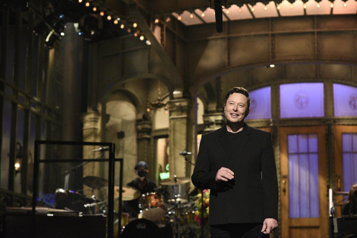 Elon Musk smiles on the "SNL" stage.