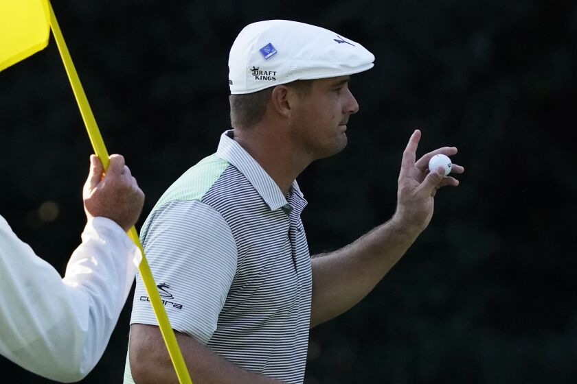 Bryson DeChambeau holds up his ball after a birdie on the sixth hole during the second round.