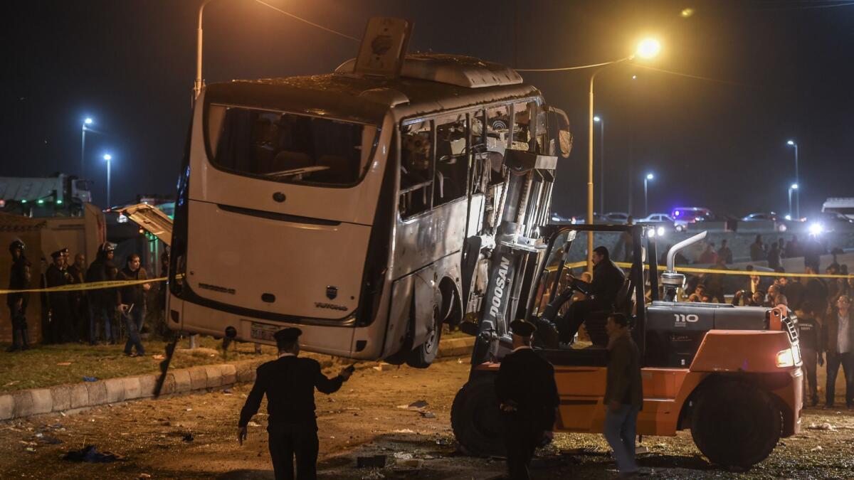 This picture taken Friday shows a tourist bus that was attacked being towed away from the scene in Giza province south of the Egyptian capital, Cairo.