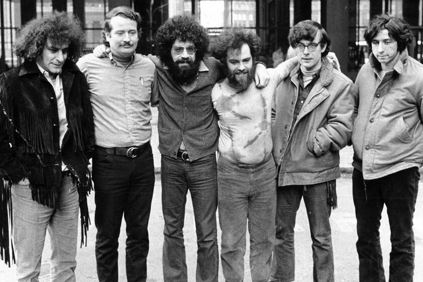 Six of the Chicago Seven defendants pose outside of the Federal Building in Chicago during their conspiracy trial on Feb. 11, 1970. From left are: Abbie Hoffman, John Froines, Lee Weiner, Jerry Rubin, Rennie Davis, and Tom Hayden.