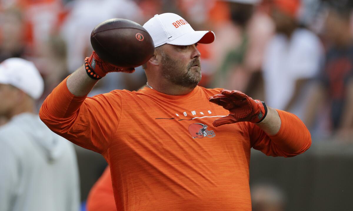 Cleveland Browns coach Freddie Kitchens throws a football.