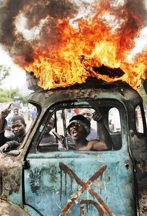Mobs in Kisumu, Kenya, armed with makeshift weapons have erected burning roadblocks, including this truck, and continue to search for the few Kikuyu targets remaining in the city. In Nairobi, the slaying of an opposition lawmaker triggered a new flare-up of the ethnic fighting that has gripped Kenya since its disputed presidential election.