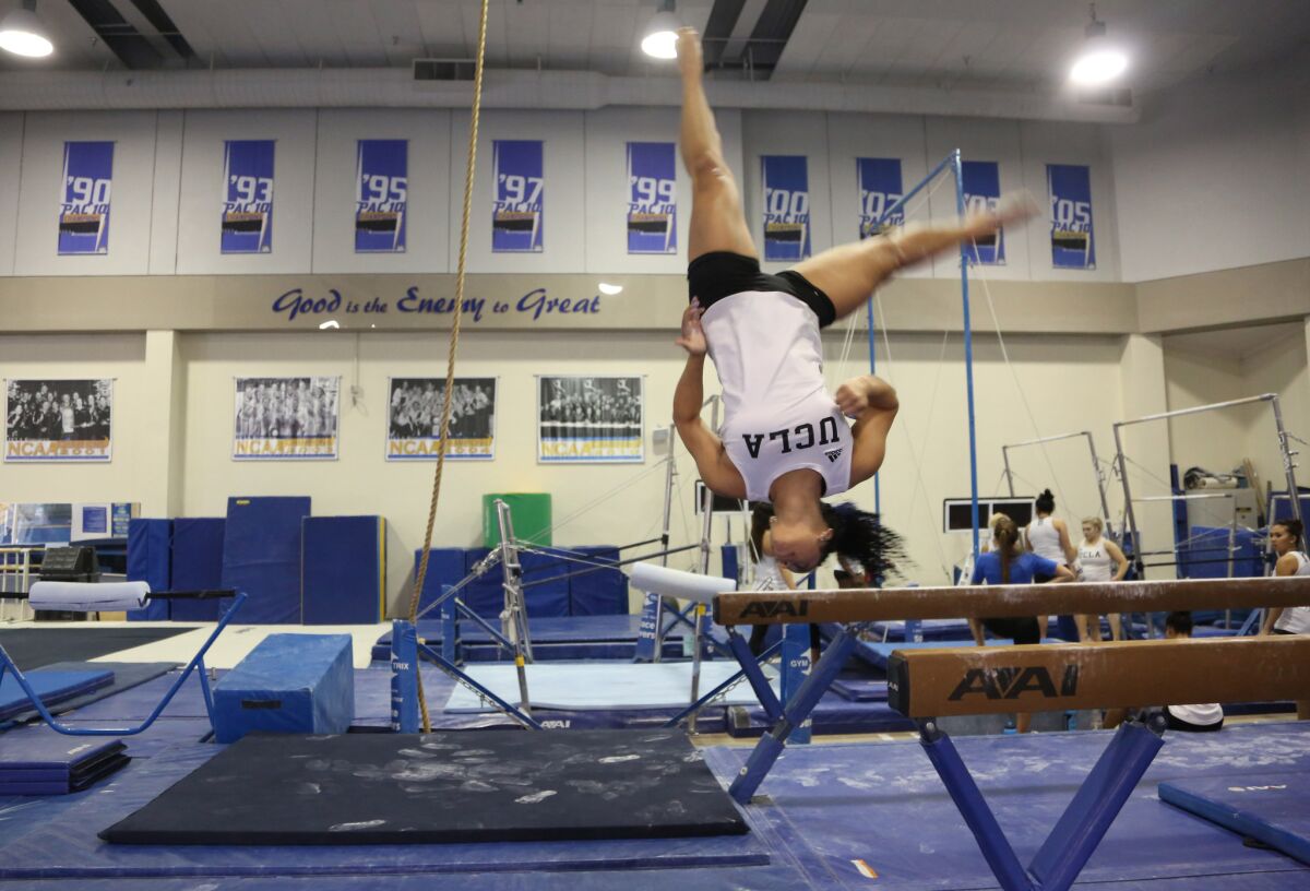 UCLA gymnast Sophina DeJesus finishes a routine on the balance beam during practice this week.