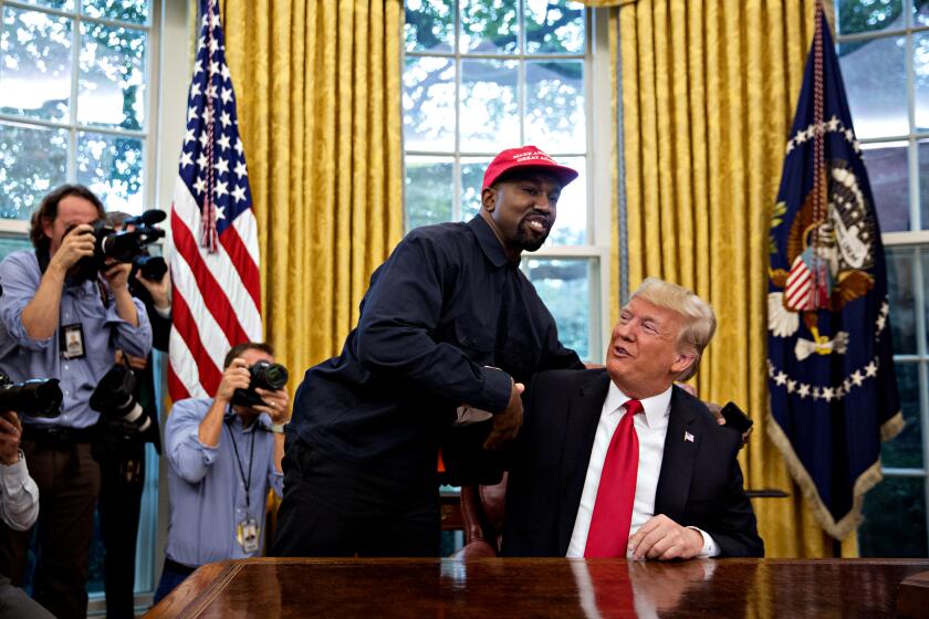 Rapper Kanye West, left, shakes hands with U.S. President Donald Trump during a meeting in the Oval Office of the White House in Washington, D.C., U.S., on Thursday, Oct. 11, 2018. West, a recording artist and prominent Trump supporter, is at the White House to have lunch with the president and to meet with presidential son-in-law and senior adviser Jared Kushner who has spearheaded the administrations efforts overhaul the criminal justice system. Photographer: Andrew Harrer/Bloomberg via Getty Images