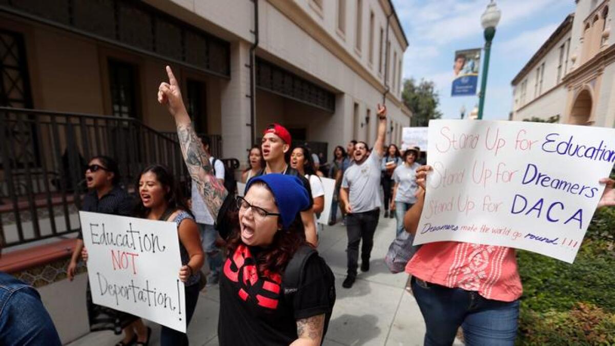 Liz Sanchez, center, a Cal State Fullerton second year graduate student and Fullerton College employee, at a rally to preserve DACA.