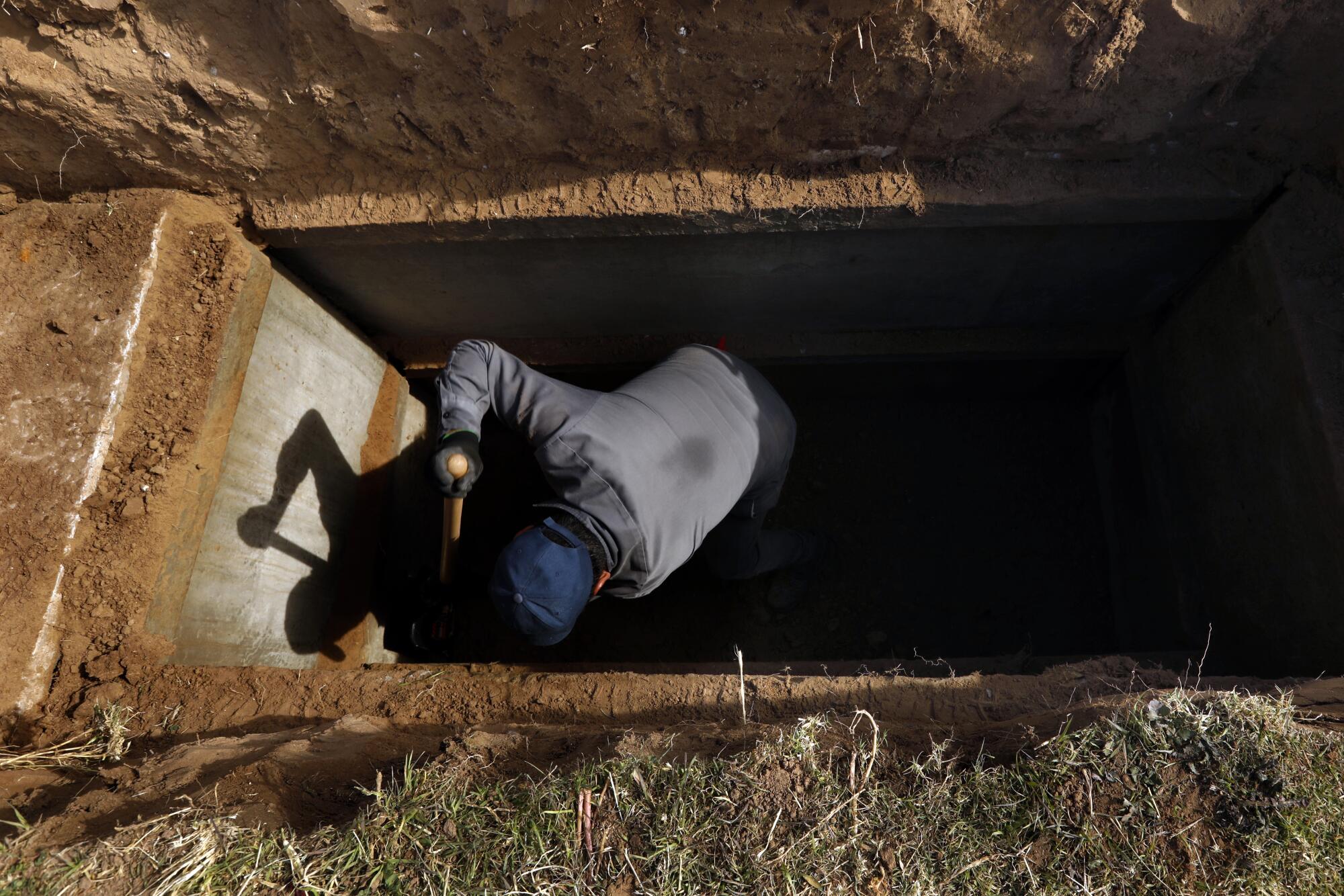 Angel Esparza, 30, started digging graves for Perches at the start of the pandemic. 