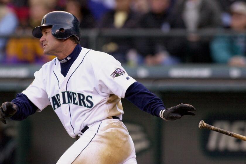 FILE - In this April 4, 2001, file photo, Seattle Mariners' Edgar Martinez drops his bat as he heads toward first on his sixth-inning, two-run double against the Oakland Athletics in Seattle. Martinez will go into the Baseball Hall of Fame on Sunday, the first player to spend his entire career with the Mariners--18 seasons in all--and find his way into Cooperstown. (AP Photo/Elaine Thompson, File)