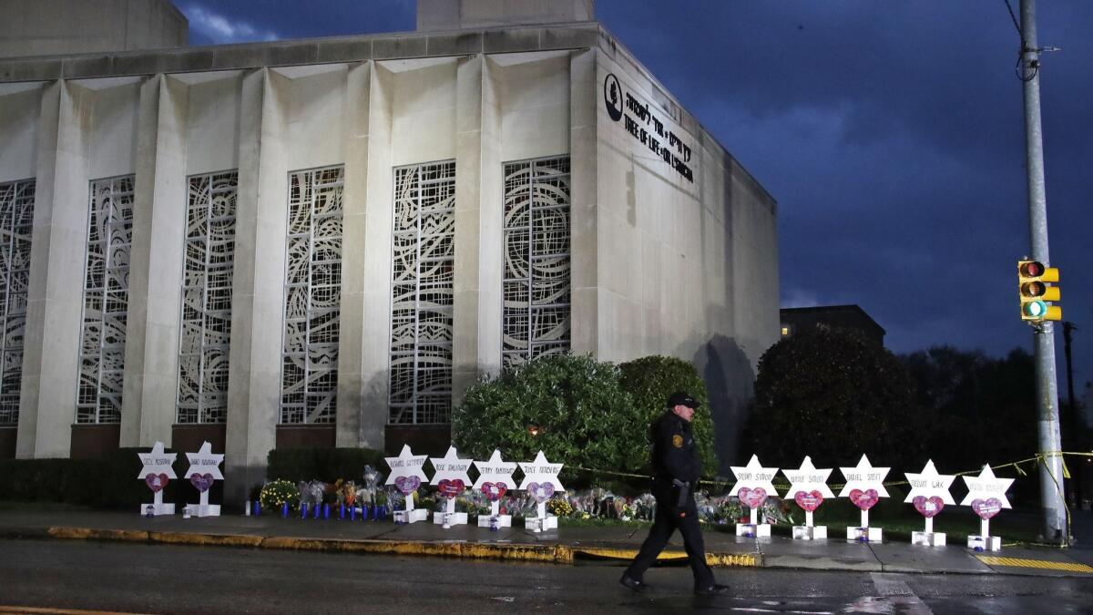 A police officer walks past the Tree of Life Synagogue in Pittsburgh, Penn. on Oct. 28. Critics say Gab, a social media site apparently used by the synagogue shooting suspect, has become a breeding ground for white nationalists, neo-Nazis and other extremists.