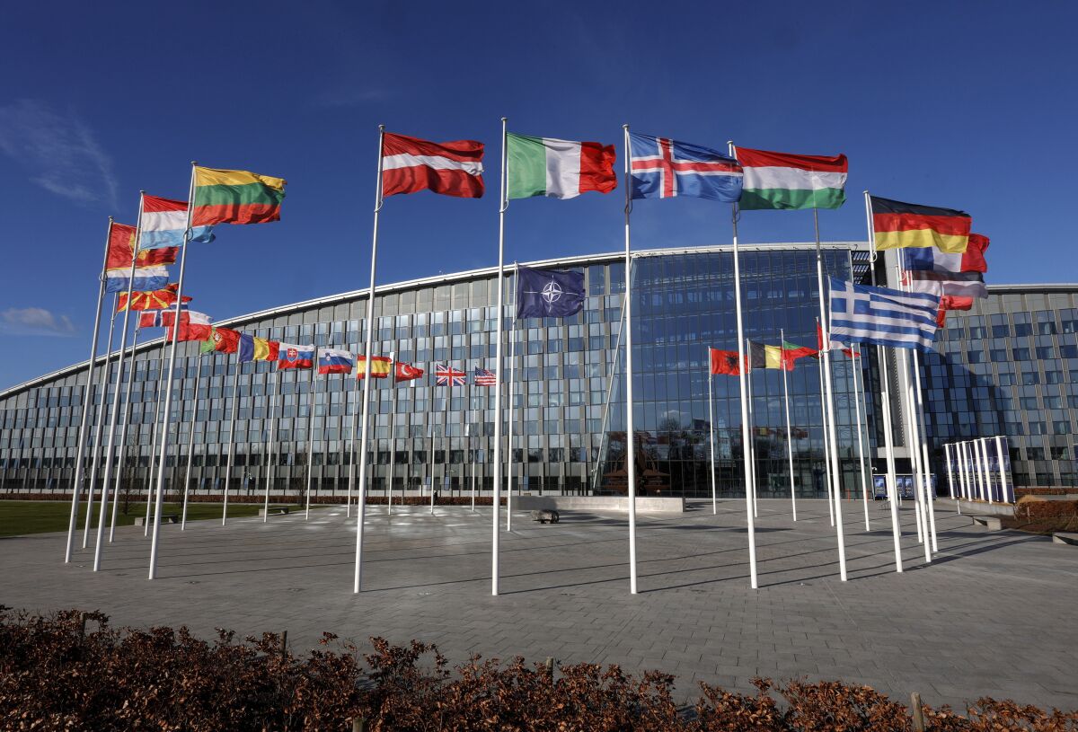 FILE - Flags flutter in the wind outside NATO headquarters in Brussels, Feb. 7, 2022. With Finland and Sweden taking steps to join NATO, the list of “neutral” countries in Europe appears poised to shrink. Security concerns over Russia’s ongoing invasion of Ukraine changed the calculus for Finland and Sweden which have long espoused neutrality and caused other traditionally “neutral” countries to re-think what that term really means for them. (AP Photo/Olivier Matthys, File)