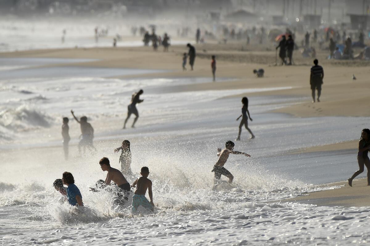 MALIBU, CALIFORNIA JULY 2, 2020-Children play in the surf on Zuma Beach in Malibu Thursday. L.A. County beaches will be closed for the July 4th weekend. (Wally Skalij/Los Angeles Times)