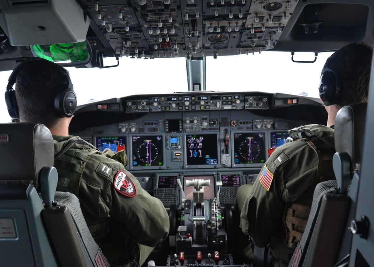 Lt. Clayton Hunt, left, and Lt. j.g. Nicholas Horton, U.S. naval aviators assigned to Patrol Squadron (VP) 16, pilot a P-8A Poseidon over the Indian Ocean during a mission to assist in the hunt for Malaysia Airlines Flight 370.
