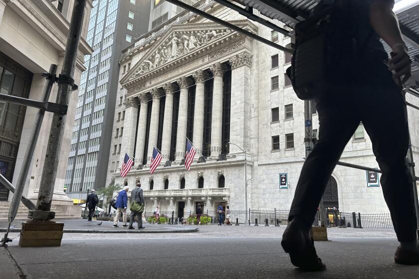 FILE - People pass the New York Stock Exchange on Aug. 27, 2024, in New York. (AP Photo/Peter Morgan, File)