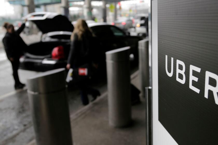 FILE - In this March 15, 2017, file photo, a sign marks a pick up point for the Uber car service at LaGuardia Airport in New York. Uber has agreed to protect customer data and audit the use of rider information in order to settle a complaint filed by the federal government. The Federal Trade Commission says Uber deceived customers by failing to secure data on where riders traveled and neglecting to monitor employee access to the information. (AP Photo/Seth Wenig, File)