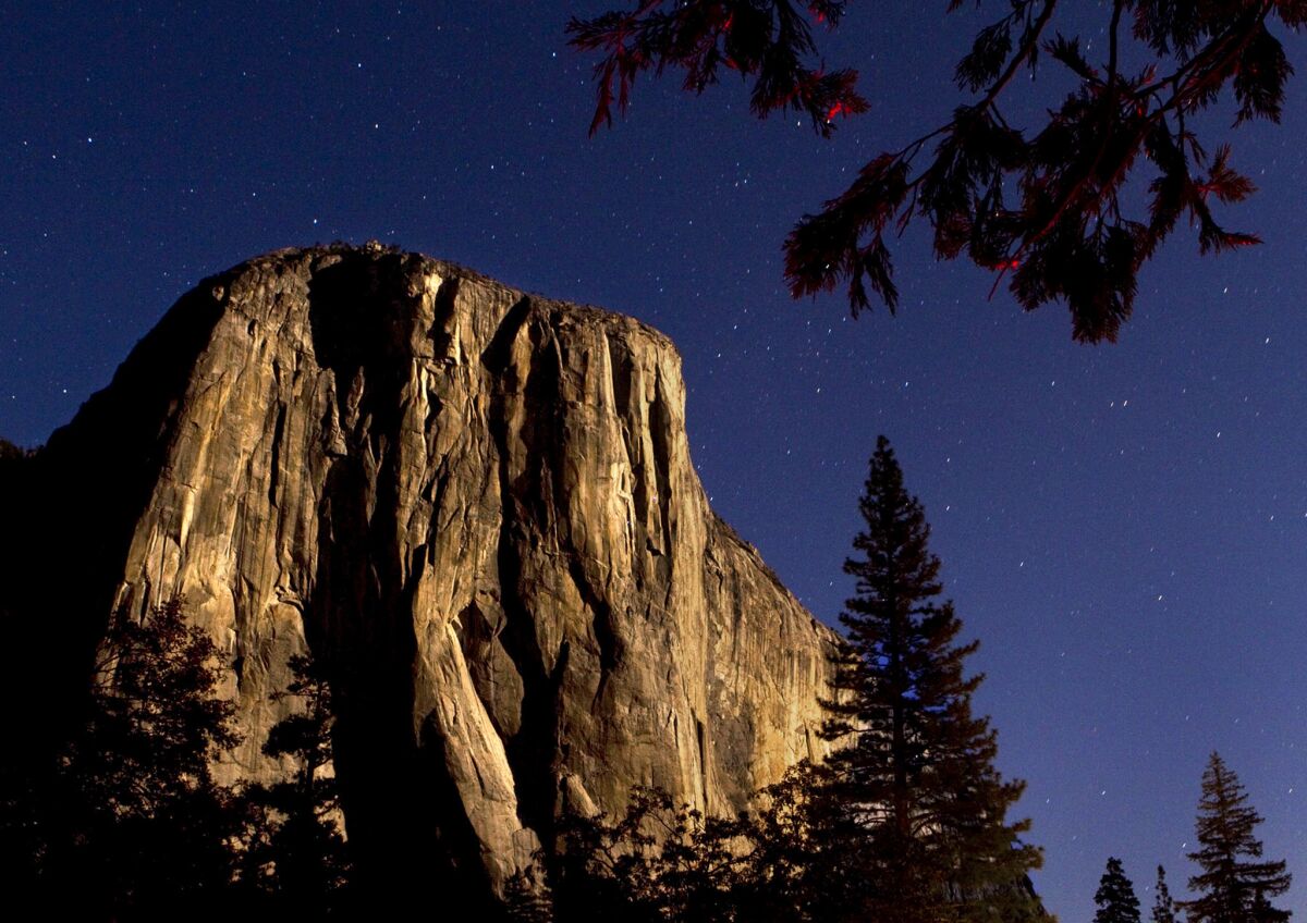 The granite monolith El Capitan is bathed in moonlight in the Yosemite Valley.