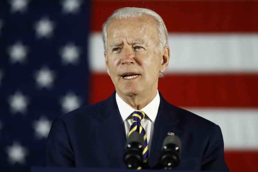 Joe Biden speaks at a lectern in front of an American flag