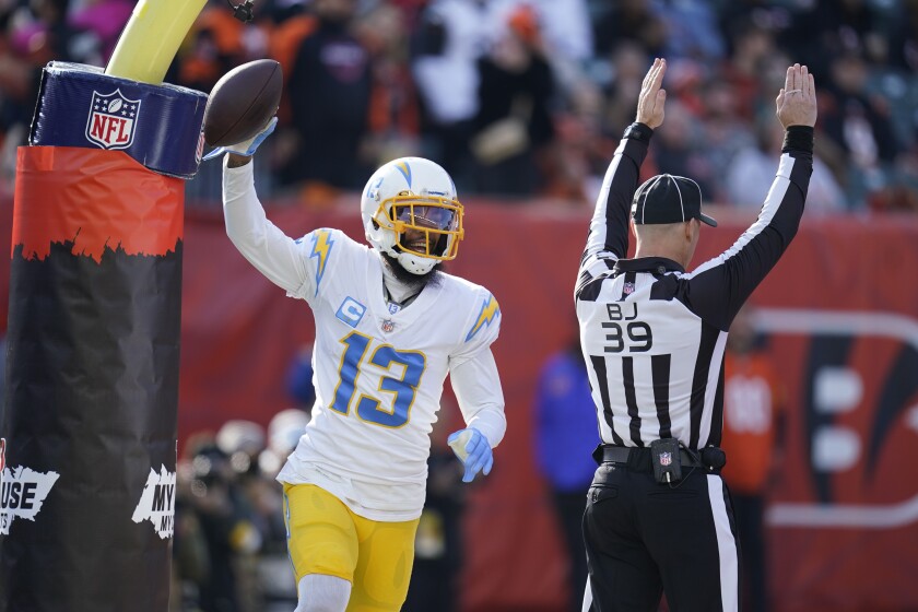 Los Angeles Chargers' Keenan Allen (13) reacts after a touchdown reception during the first half of an NFL football game against the Cincinnati Bengals, Sunday, Dec. 5, 2021, in Cincinnati. (AP Photo/Michael Conroy)