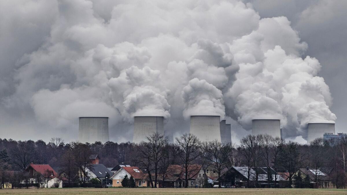 In this Jan.6, 2019, file photo water vapor rises from the cooling towers of the Joenschwalde lignite-fired power plant of Lausitz Energie Bergbau AG in Brandenburg, Germany.