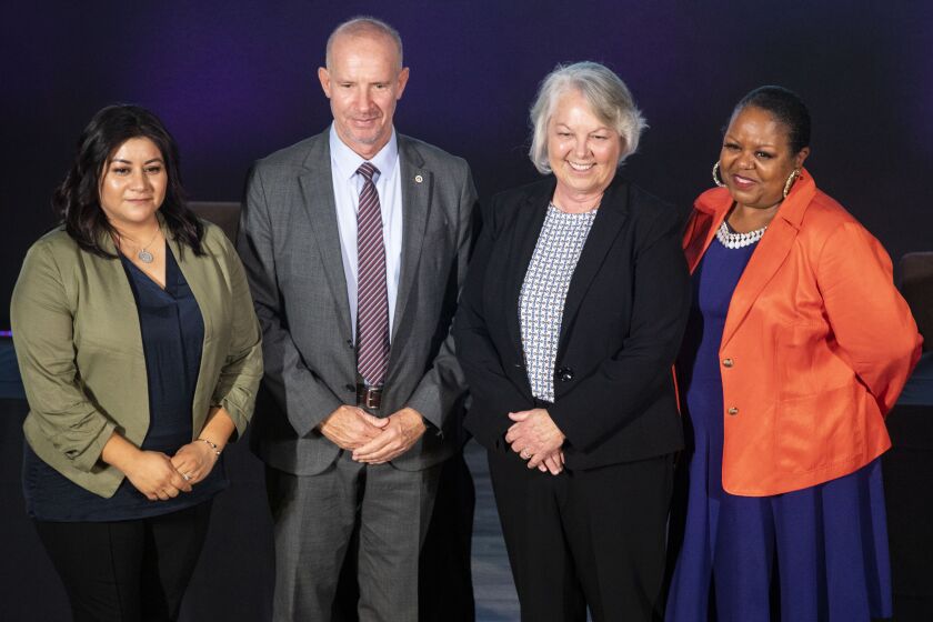 San Diego, CA - September 28: San Diego County Sheriff candidates John Hemmerling and Kelly Martinez, center, pose for a photo with Wendy Baez and Danyrea 'Cookie' Megginson after participatiing in a candidate forum hosted by the San Diego Organizing Project at City of Hope International Church on Wednesday, Sept. 28, 2022 in San Diego, CA. (Meg McLaughlin / The San Diego Union-Tribune)
