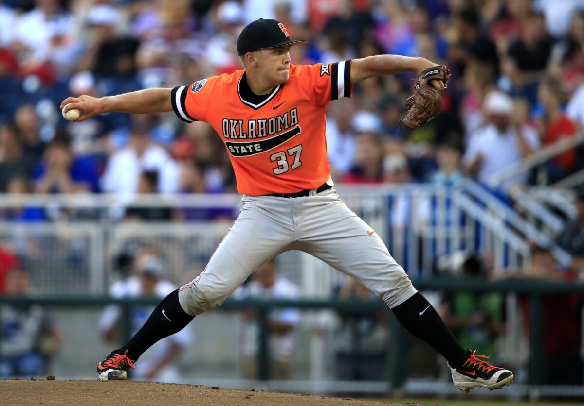 Oklahoma State starting pitcher Tyler Buffett throws during the first inning of a College World Series game against Arizona.