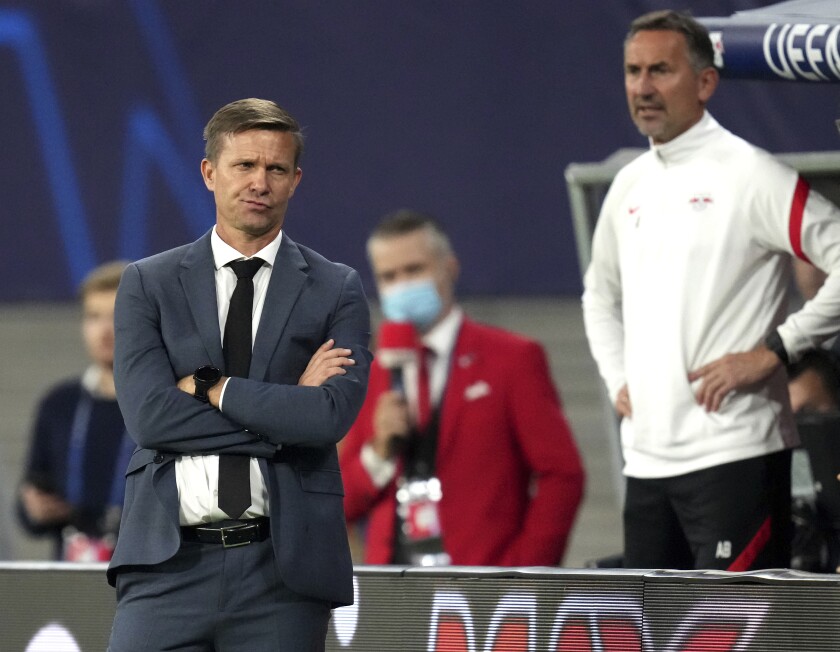 FILE - Leipzig's head coach Jesse Marsch, left, reacts during the Group A Champion's League soccer match between RB Leipzig and Club Brugge at the Red Bull Arena in Leipzig, Germany, on Sept. 28, 2021. At right is Leipzig's assistant coach Achim Beierlorzer, who will replace him. American Jesse Marsch is no longer coach of Bundesliga team Leipzig. The club said Sunday that the two had “mutually agreed to end the cooperation. That is the result of an in-depth analysis and intensive discussions” after Friday’s 2-1 loss at Union Berlin. (AP Photo/Michael Sohn, file)