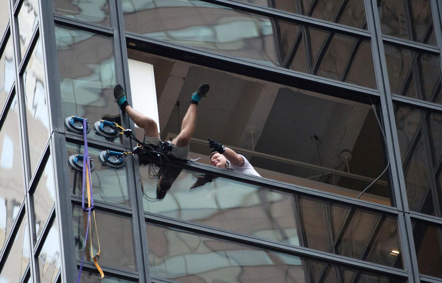 Police grab a man scaling Trump Tower using suction cups on Aug. 10, 2016, in New York.