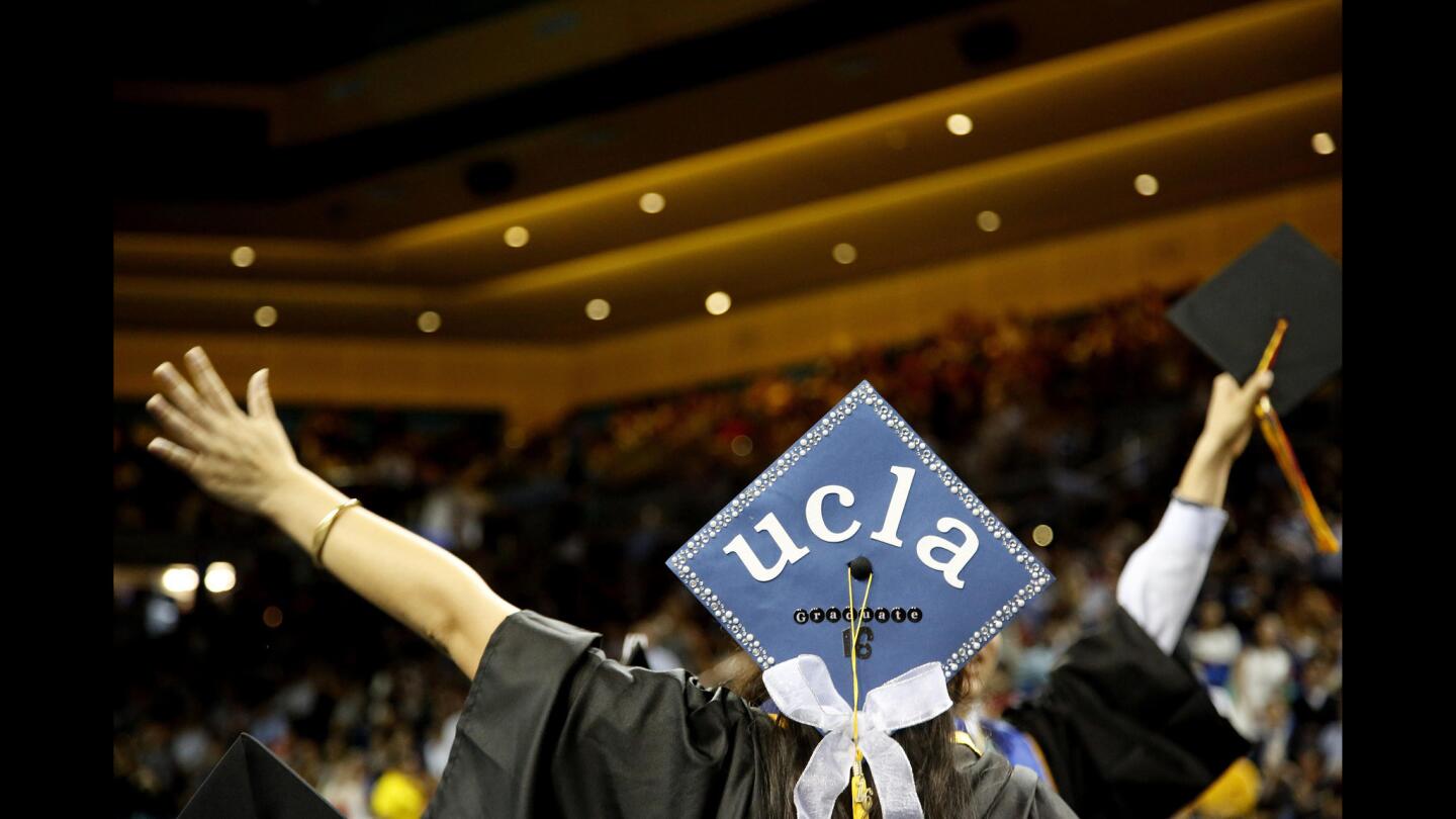 A student cheers during commencement ceremonies at the Pauley Pavilion in Westwood Plaza.