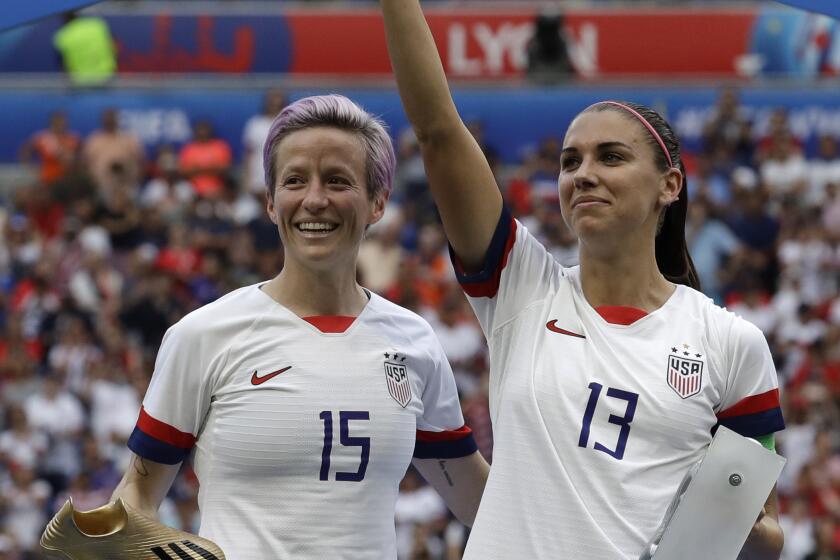 United States' Megan Rapinoe, left, and her teammate Alex Morgan, right, react after winning the Women's World Cup final.