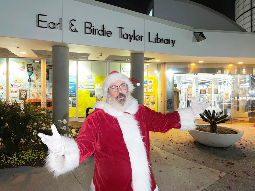 Evan Fickling, a librarian at the Pacific Beach/Taylor Library, will represent Santa during the branch’s Santa Storytime.