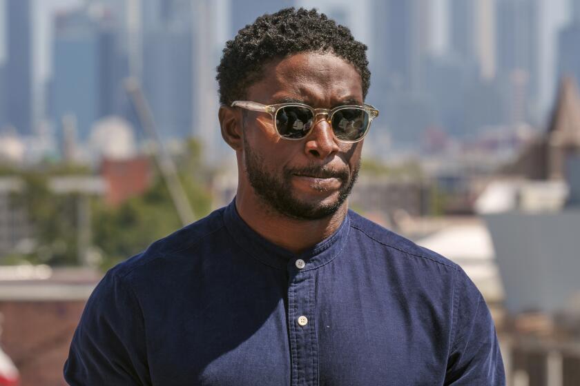 Former USC football player Reggie Bush listens to questions during a news conference at the Coliseum 