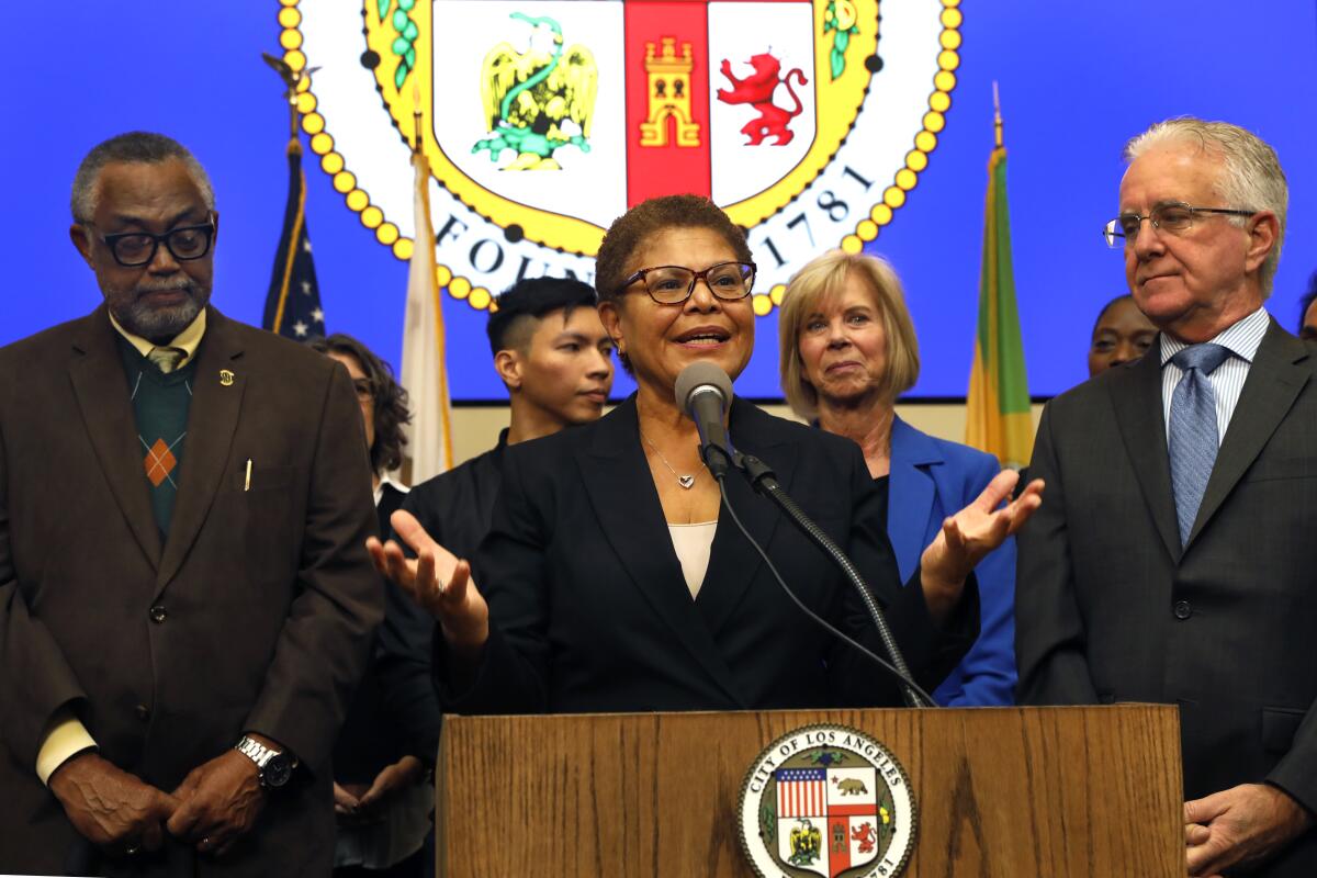 Mayor Karen Bass speaks  from behind the lectern at the L.A. Emergency Operations Center.