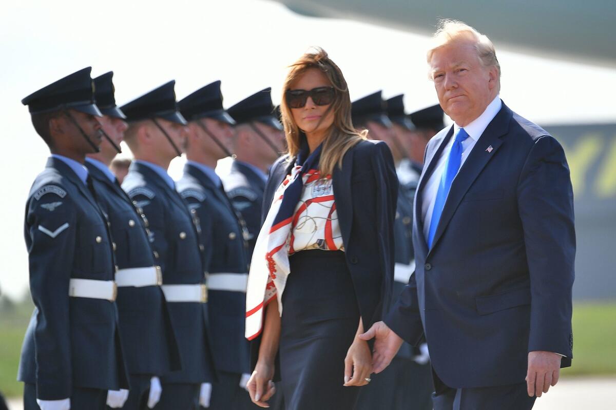 President Donald Trump and First Lady Melania Trump walk to the Marine One helicopter after disembarking Air Force One at Stansted Airport, north of London.