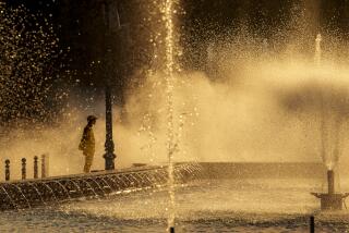 A municipal worker cools off standing next to a city fountain in Bucharest, Romania, Thursday, July 11, 2024, as temperatures exceeded 39 degrees Celsius (102.2 Fahrenheit). The national weather forecaster issued a red warning for the coming week, as temperatures are expected to exceed 40 degrees Celsius (104 Fahrenheit). (AP Photo/Vadim Ghirda)