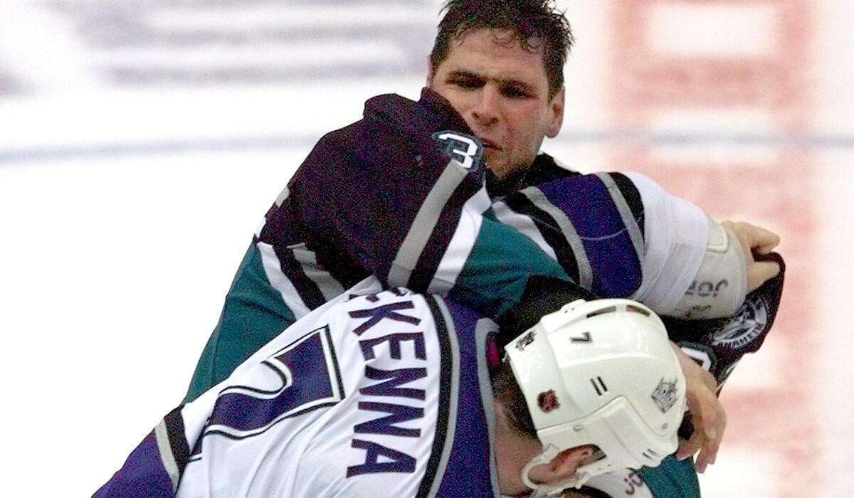 Stu Grimson of the Ducks and Steve McKenna of the Kings trade punches during the early days of their co-existence. The looming playoff series could heighten the nature of their rivalry.