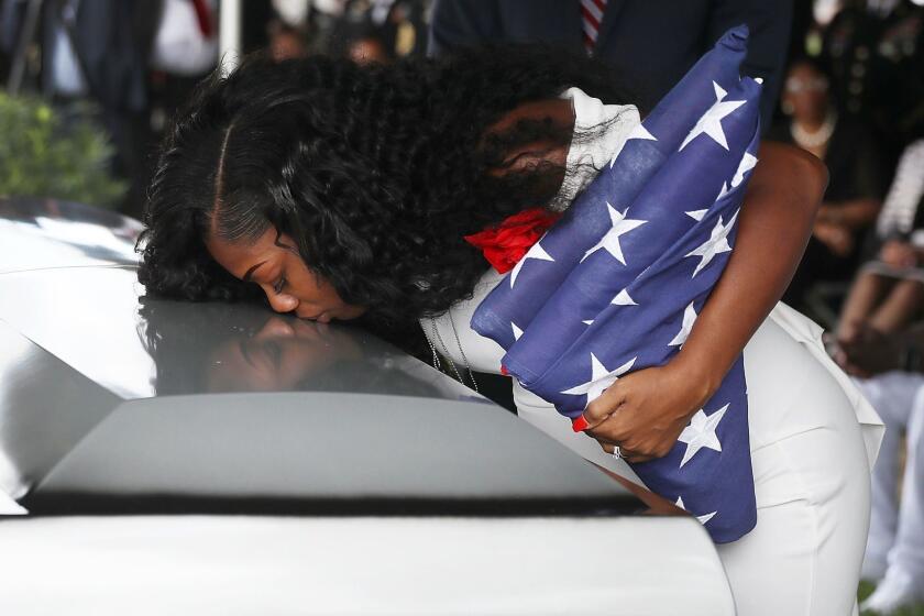 HOLLYWOOD, FL - OCTOBER 21: Myeshia Johnson kisses the casket of her husband U.S. Army Sgt. La David Johnson during his burial service at the Memorial Gardens East cemetery on October 21, 2017 in Hollywood, Florida. Sgt. Johnson and three other American soldiers were killed in an ambush in Niger on Oct. 4. (Photo by Joe Raedle/Getty Images) ***BESTPIX*** ** OUTS - ELSENT, FPG, CM - OUTS * NM, PH, VA if sourced by CT, LA or MoD **