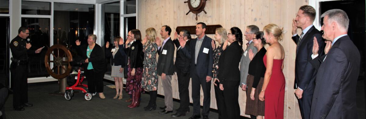 Northern Division Police Captain Matt Novak delivers the oath of office to PB Town Council members.