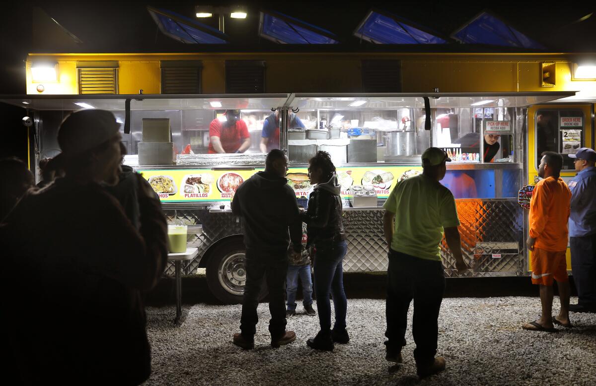 Taco stands and loncheras — like this one pictured in Hesperia in 2020 — face intense competition for available public space.